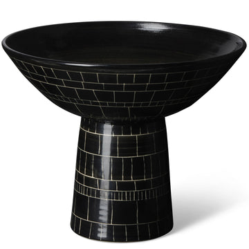 A footed black and white ceramic bowl with geometric patterns.